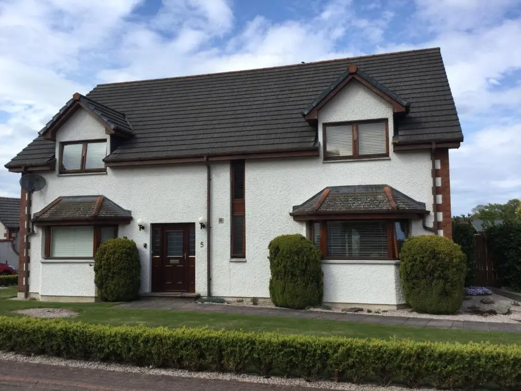 a white house with a black roof at West Heather House Free Parking in Inverness