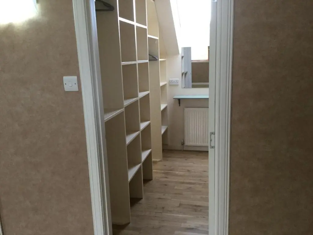 a hallway with white shelves in a room at West Heather House Free Parking in Inverness