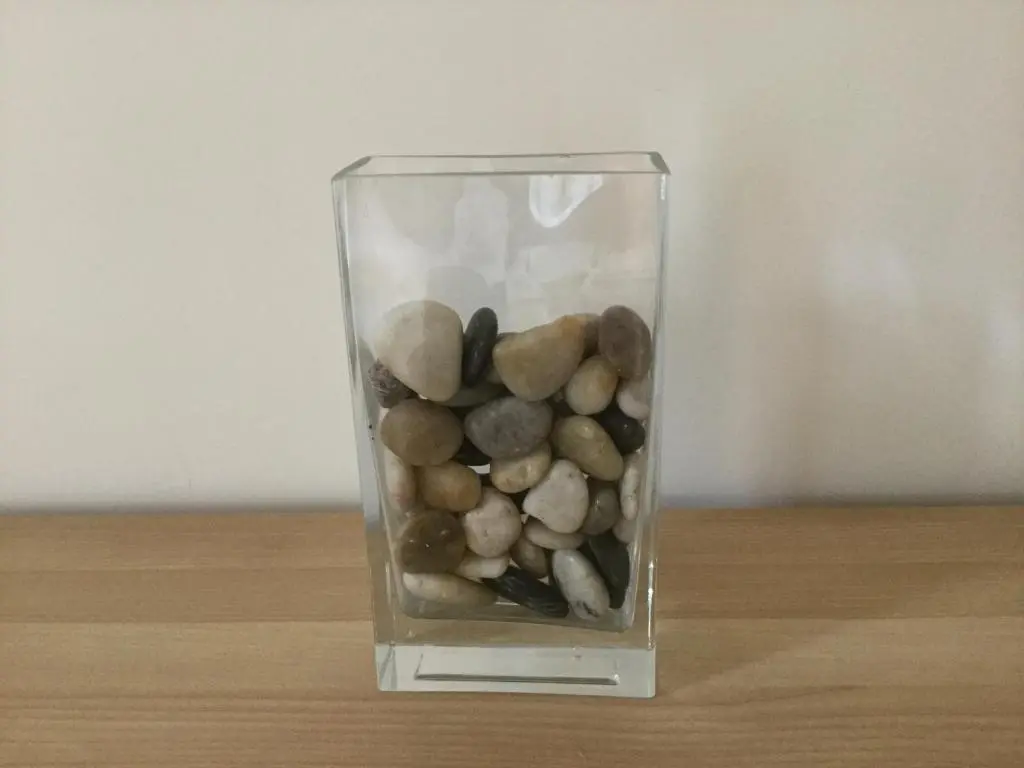 a glass vase filled with rocks on a table at Castle Heather House Free Parking in Inverness