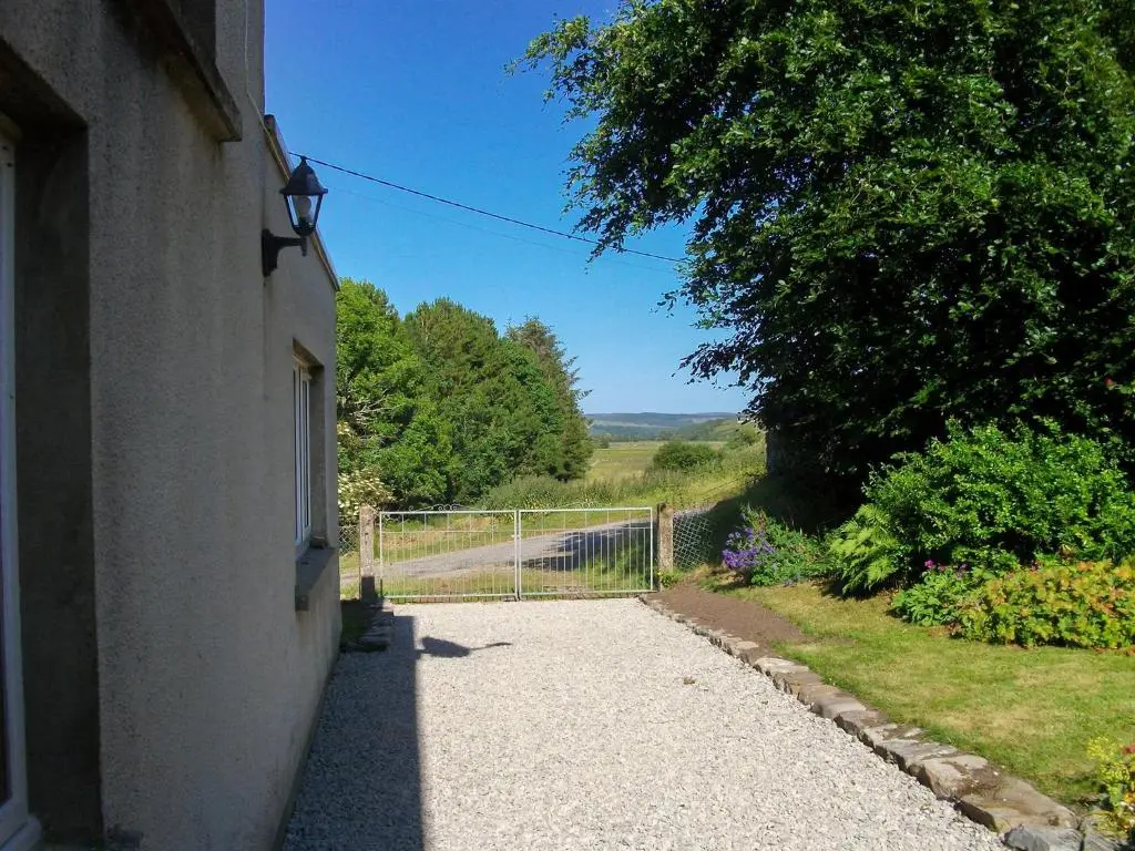 a walkway leading to a house with a gate at Lower Brae in Achnahanat