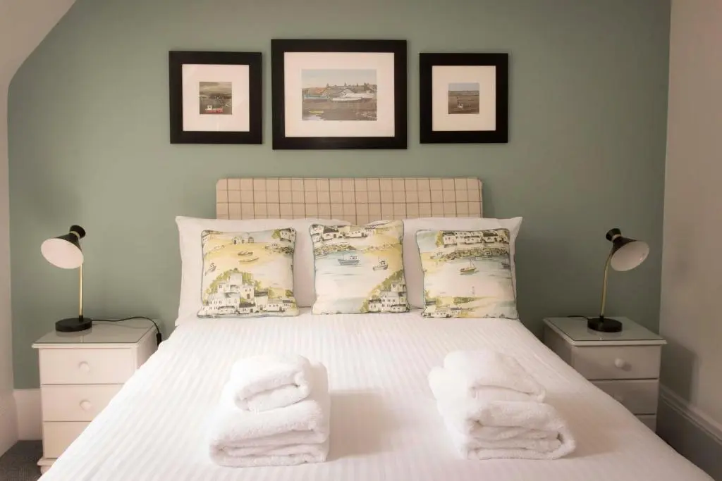 a bedroom with a bed with towels on it at The Royal Oak Hotel in Cullen