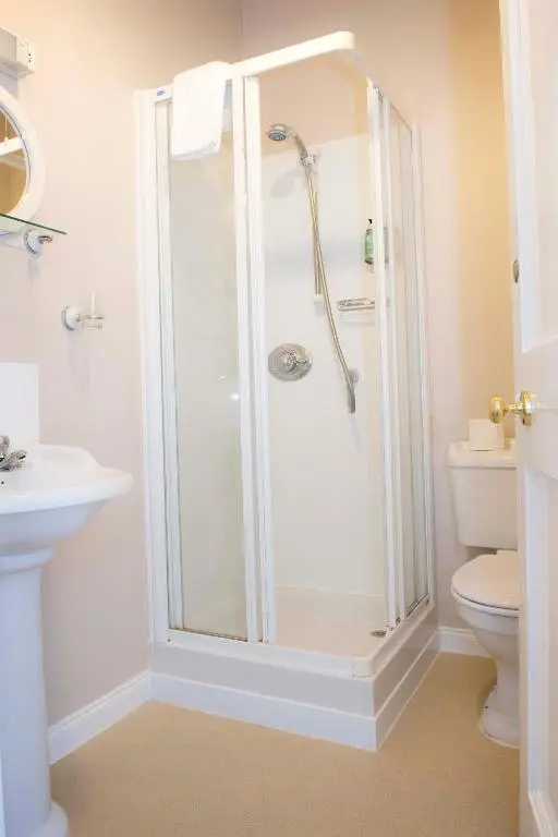 a bathroom with a shower and a toilet at The Royal Oak Hotel in Cullen