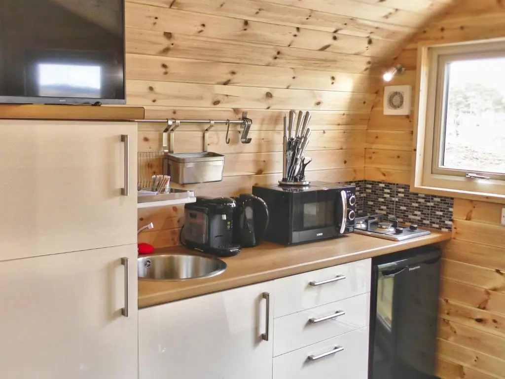 a kitchen with a sink and a microwave at Tigh an Each B&B & Laggan Glamping in Newtonmore
