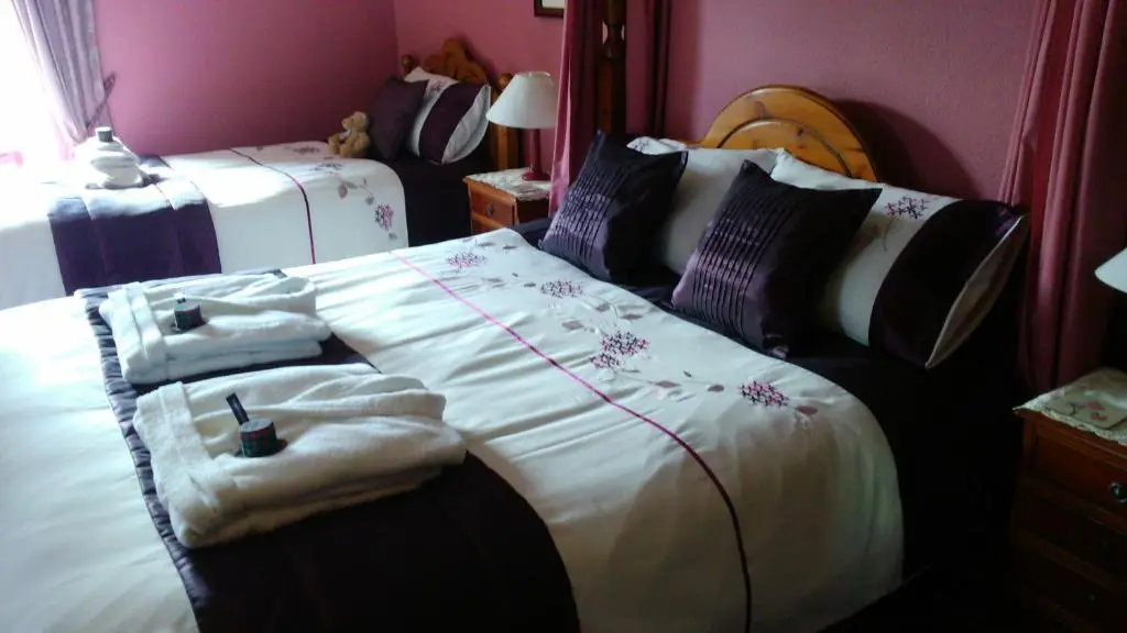 a bedroom with a bed with towels on it at Disblair House in Newmachar