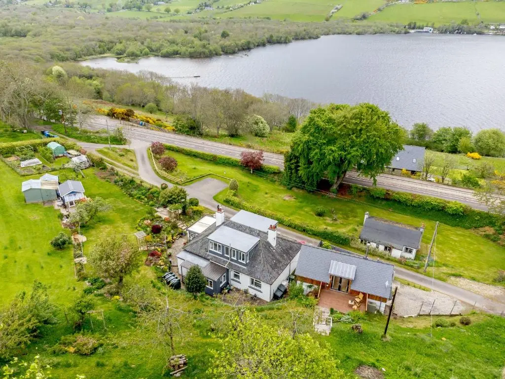 an aerial view of a house and a lake at Urquhart Bay B&B in Drumnadrochit