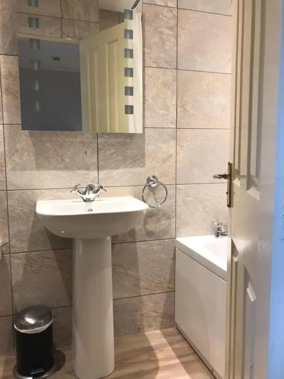 a bathroom with a sink and a mirror at Cairngorm Hotel in Aviemore