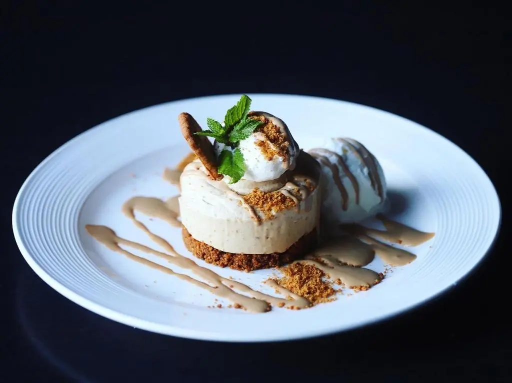 a white plate with a dessert on a table at Ardennan House Hotel in Inverurie