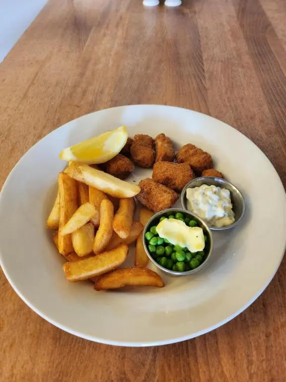 a plate of food with french fries and dips at Garth Hotel in Grantown on Spey