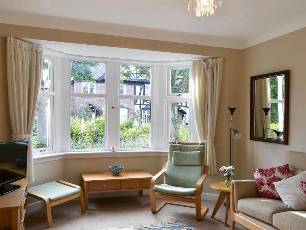 a living room with a couch and two windows at Viewhill Villa in Inverness