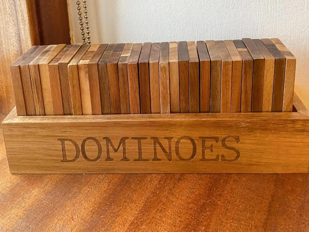 a wooden box with the word dominos written on it at Riverside Cottage in Drumnadrochit