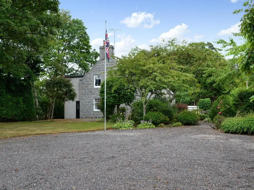 an old house with a tower on top of it at The Coach House in Alford