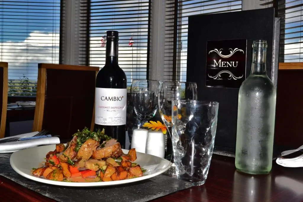a table with a plate of food and two bottles of wine at Stotfield Hotel in Lossiemouth