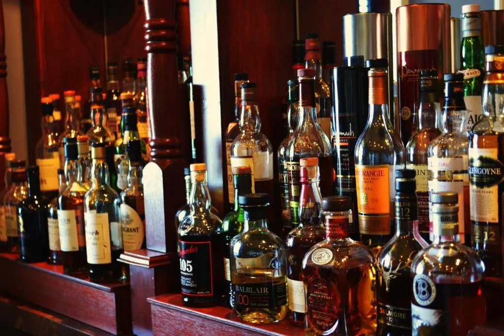 a bunch of bottles of alcohol on a bar at Stotfield Hotel in Lossiemouth