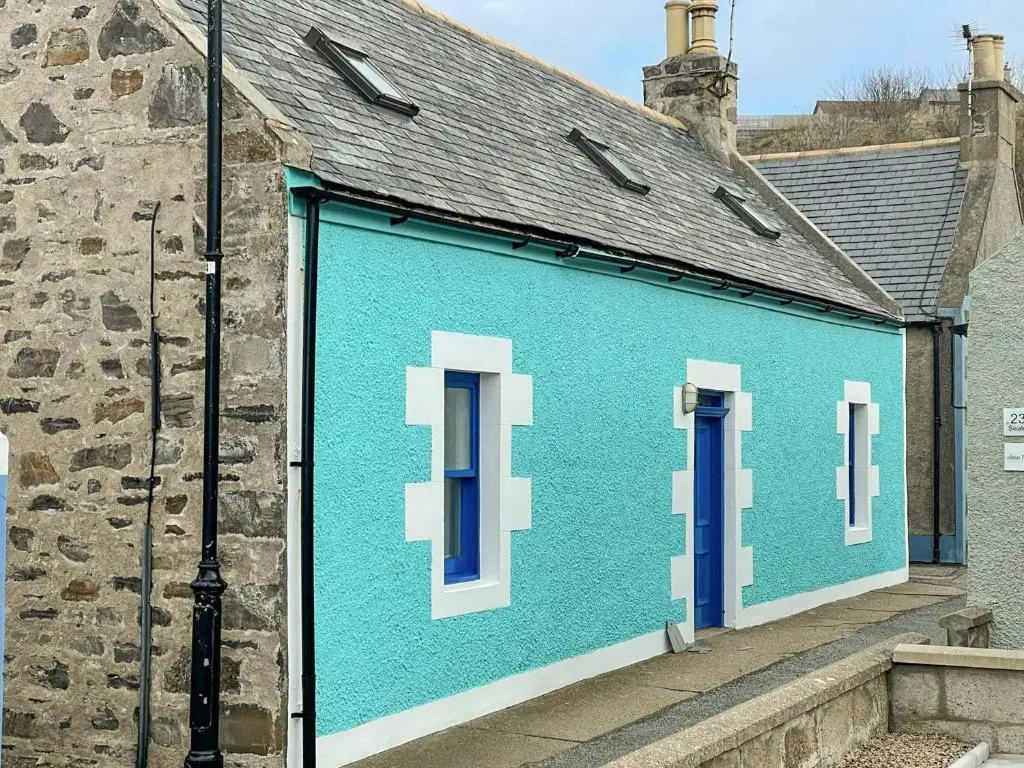 a building with blue paint on the side of it at Jebel in Cullen