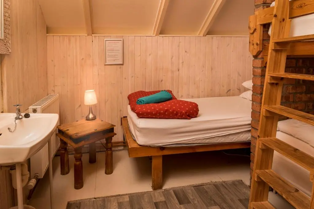 a room with a bunk bed and a sink at Gulabin Lodge in Glenshee
