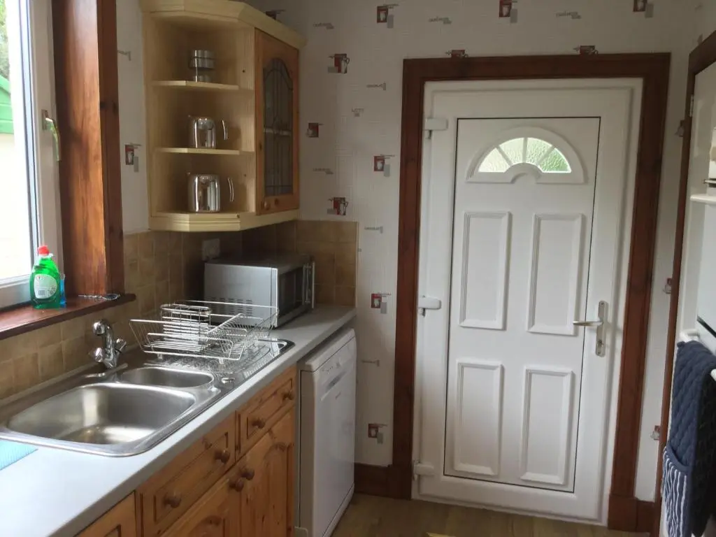 a kitchen with a sink and a white door at 3 Bedroom Culduthel House Free Parking in Inverness