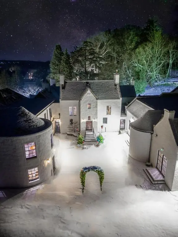 an aerial view of a house at night at Maryculter House in Maryculter