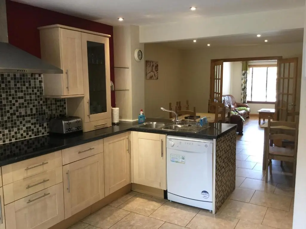 a kitchen with a sink and a dishwasher at Four-Bedroom House - Stratherrick Free Parking in Inverness