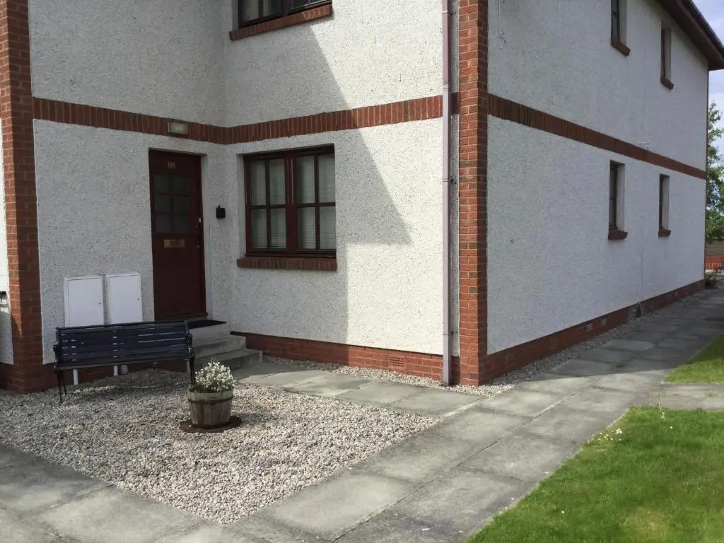 a building with a bench in front of it at One-Bedroom Apartment - Wyvis Free Parking in Inverness