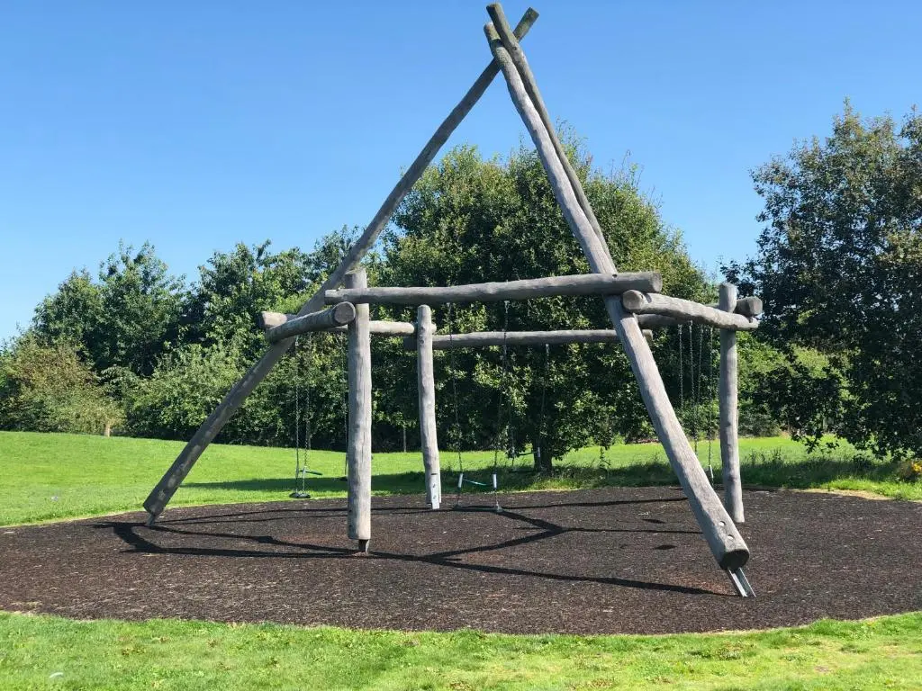 a wooden swing set in a park at One-Bedroom Apartment - Wyvis Free Parking in Inverness