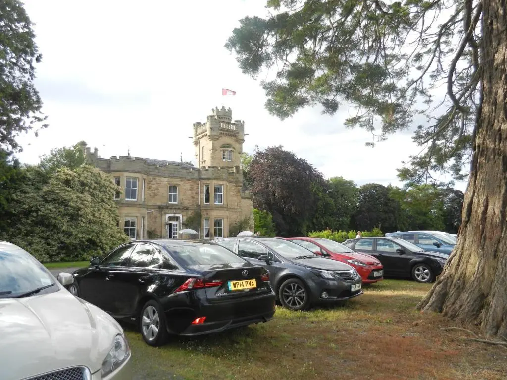 a group of cars parked in front of a building at Mansfield Castle Hotel in Tain