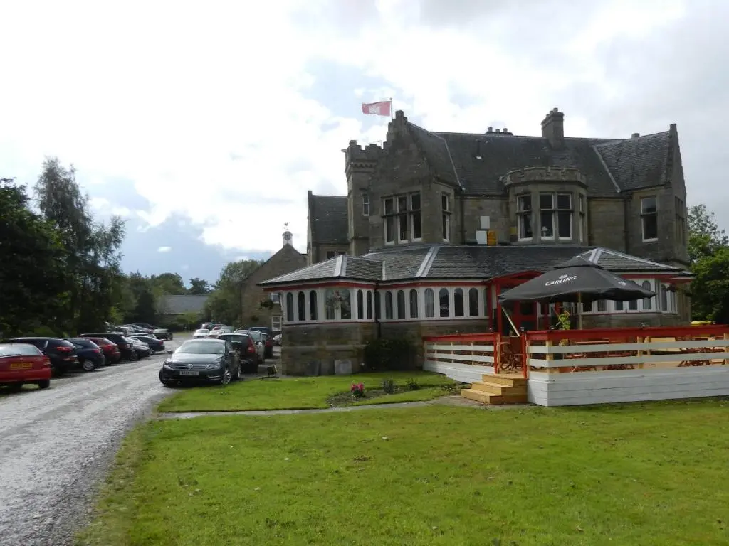 a large house with cars parked in front of it at Morangie Hotel Tain in Tain