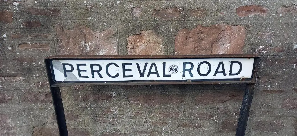 a street sign on the side of a brick wall at Fairfield Townhouse Guest House in Inverness