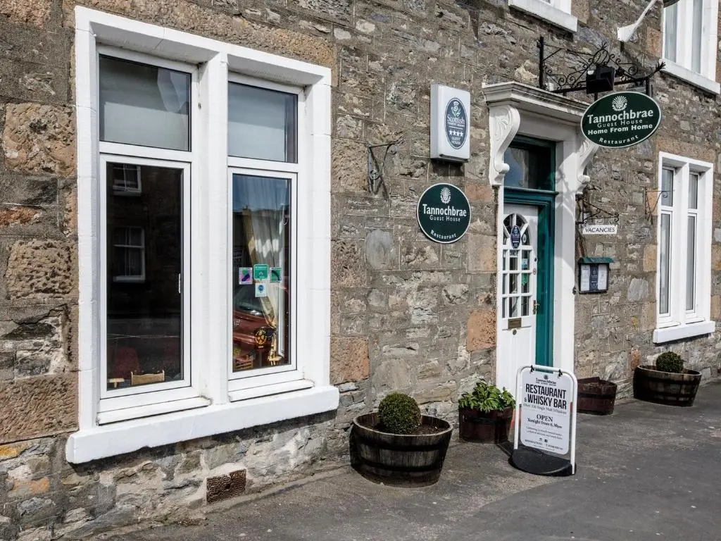 a store with a sign in front of a building at The Tannochbrae in Dufftown