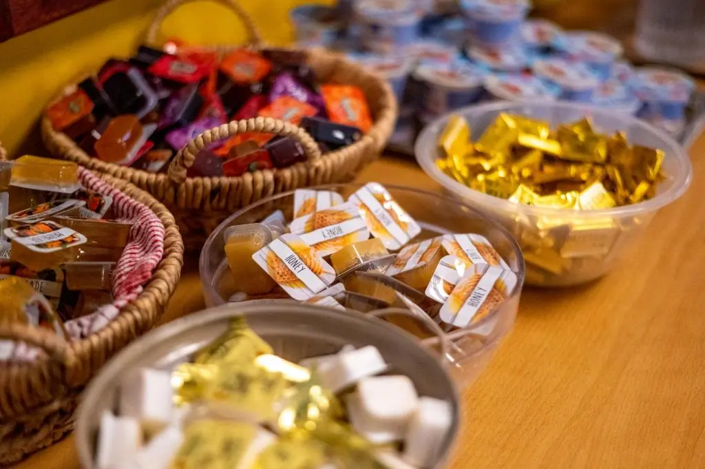 a table topped with baskets of different types of candy at Inverness Youth Hostel in Inverness