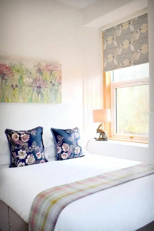 a bedroom with two beds and a window at The \u2018Servants Quarters@Delny House\u2019 in Invergordon