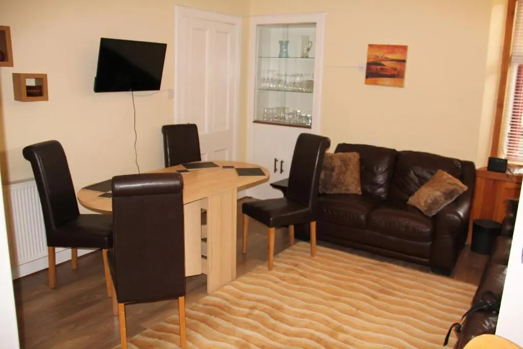 a living room with a couch and a table at Reay Street Apartment in Inverness