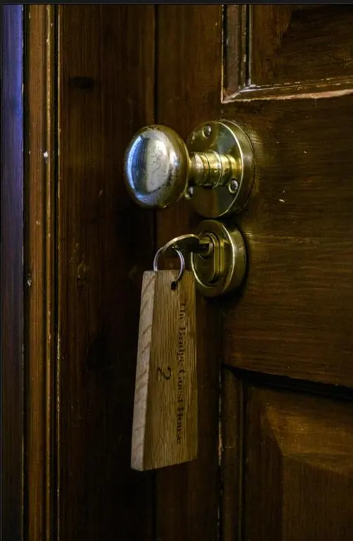 a wooden door with a tag on it at The Bridge Helmsdale in Helmsdale