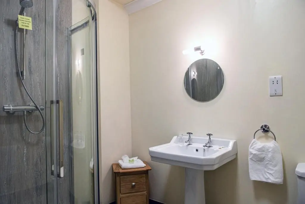 a bathroom with a sink and a shower at The Bridge Helmsdale in Helmsdale