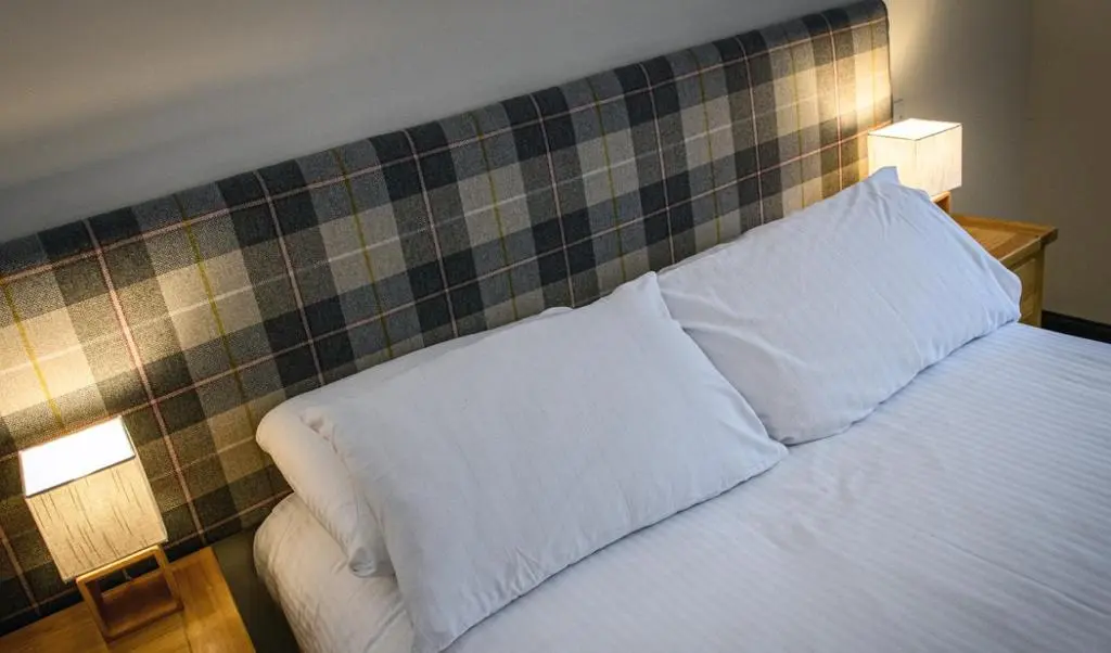 a bedroom with a bed with two pillows on it at The Bridge Helmsdale in Helmsdale