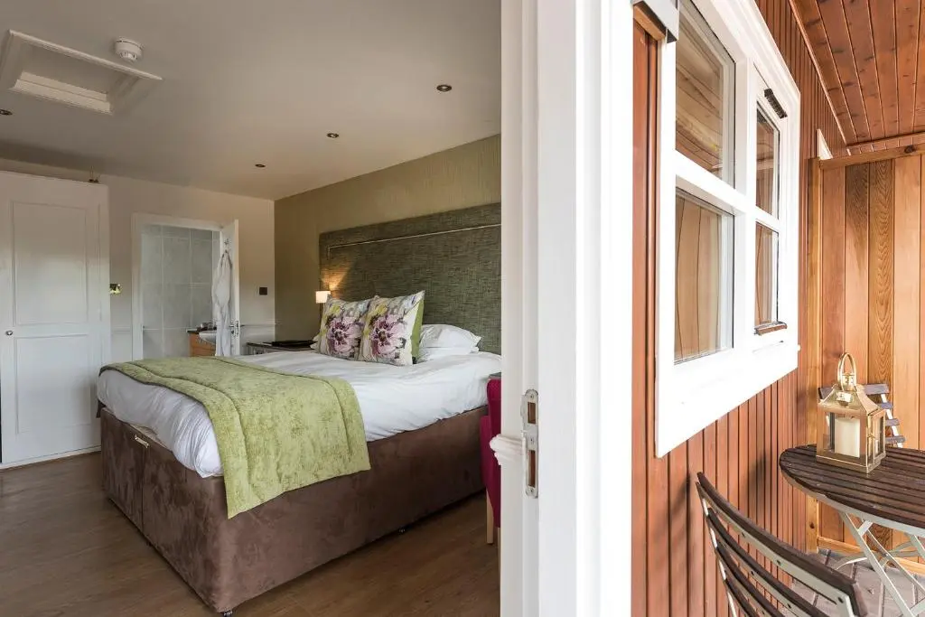 a bedroom with a large bed and a window at The Lovat, Loch Ness in Fort Augustus