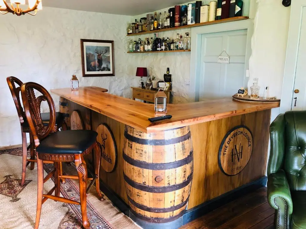 a bar made out of wine barrels in a room at Netherdale House & The Coach House in Turriff