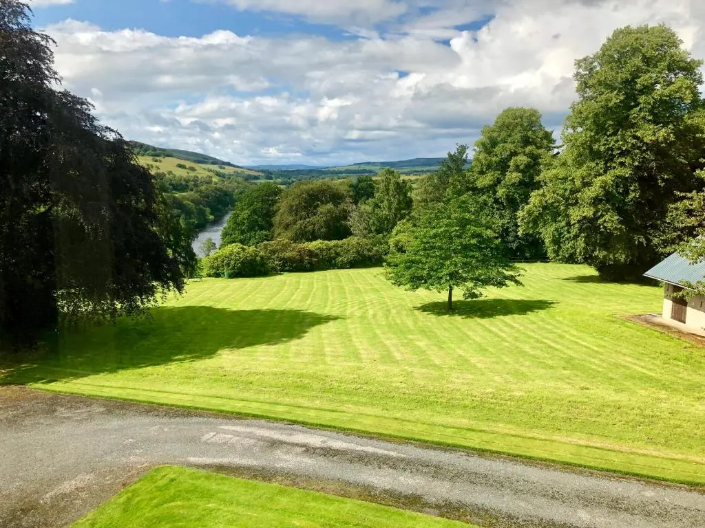 an aerial view of a green field with a tree at Netherdale House & The Coach House in Turriff
