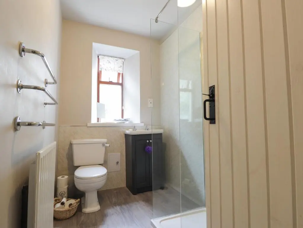 a bathroom with a toilet and a sink and a shower at St Magnus Haven in Pennan