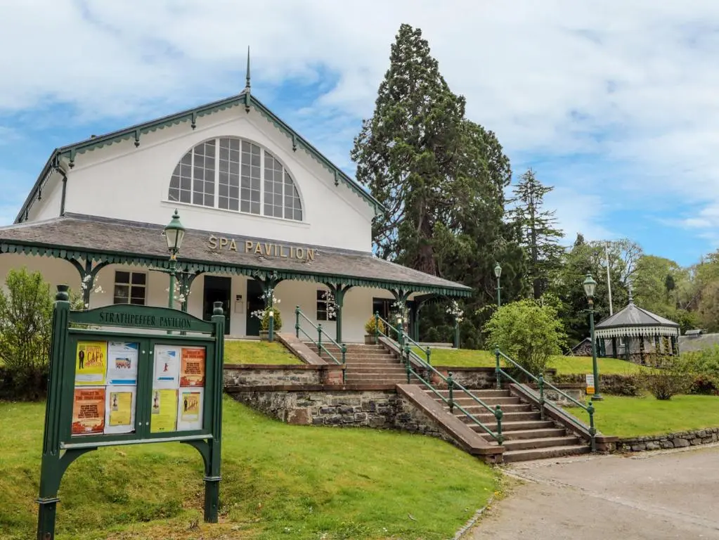 a building with a sign in front of it at Eagle Lodge in Strathpeffer