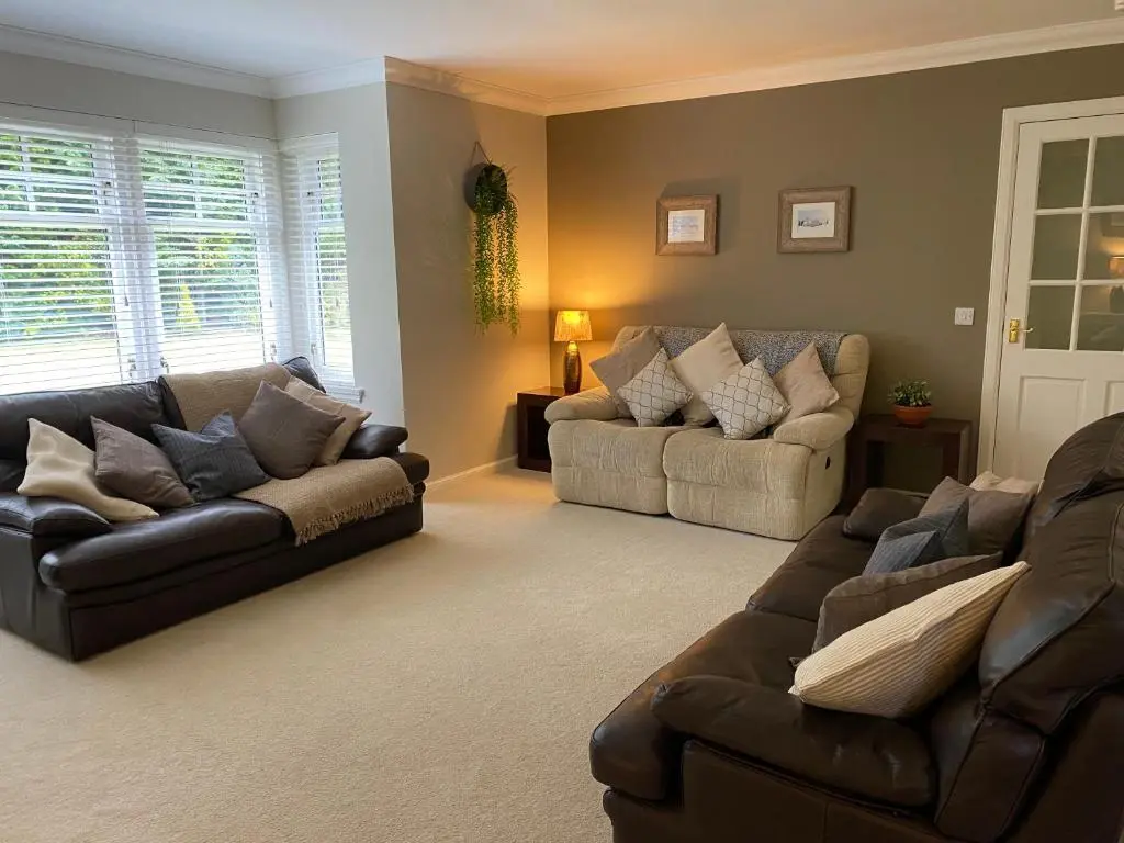 a living room with two couches and a couch at Westwood Cottage in Aboyne