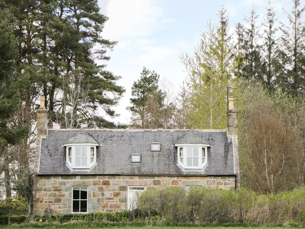 an old stone house with two windows on it at Annfield in Aberlour