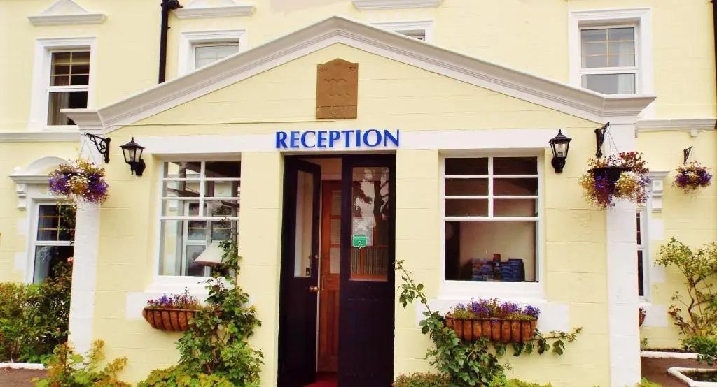 a yellow building with a rejection sign on it at The Portland Hotel in Lybster