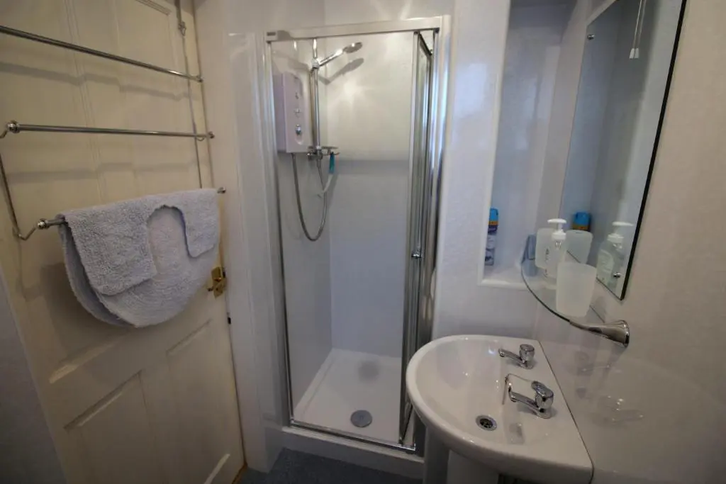 a bathroom with a shower and a sink at Easdale House Apartments in Inverness