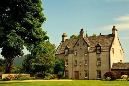 an old house with a tree in front of it at Dandaleith Cottage No.2 in Craigellachie