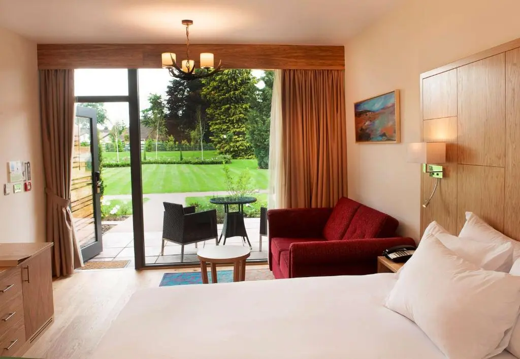 a hotel room with a bed and a living room at Kingsmills Hotel in Inverness