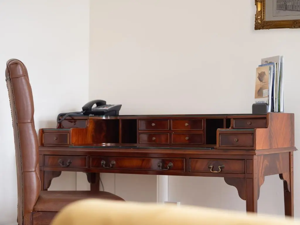 a wooden desk with a telephone on top of it at Grant Arms Hotel in Grantown on Spey