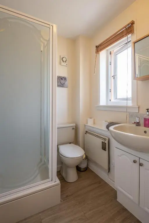 a bathroom with a toilet and a sink and a shower at White Corries in Aviemore