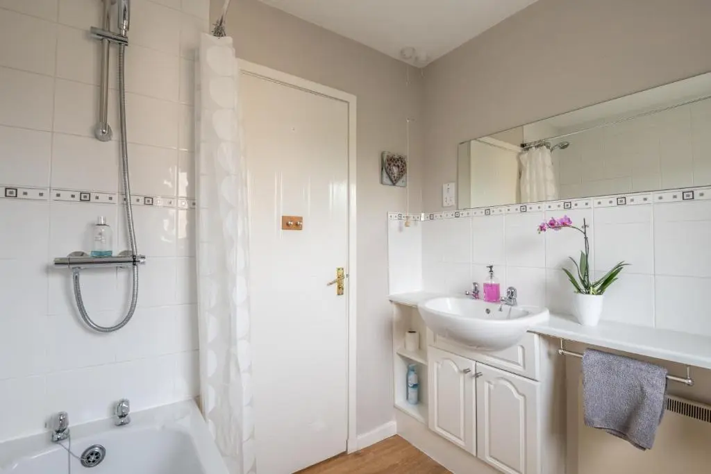 a bathroom with a tub and a sink and a shower at White Corries in Aviemore