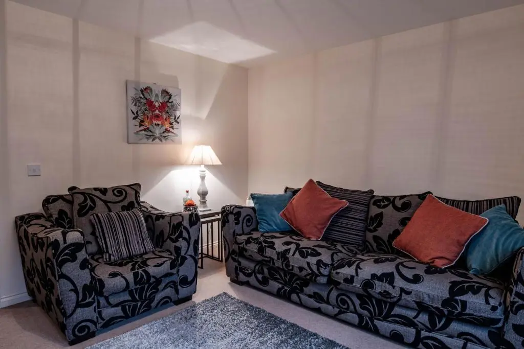 a living room with two chairs and a couch at No.3 On The Square in Beauly