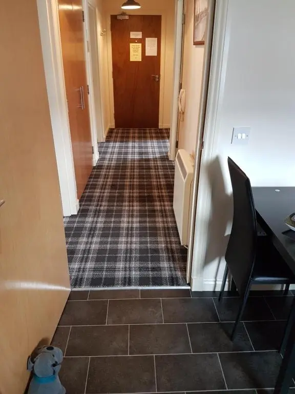 a hallway with a dog sitting on the floor at No.3 On The Square in Beauly